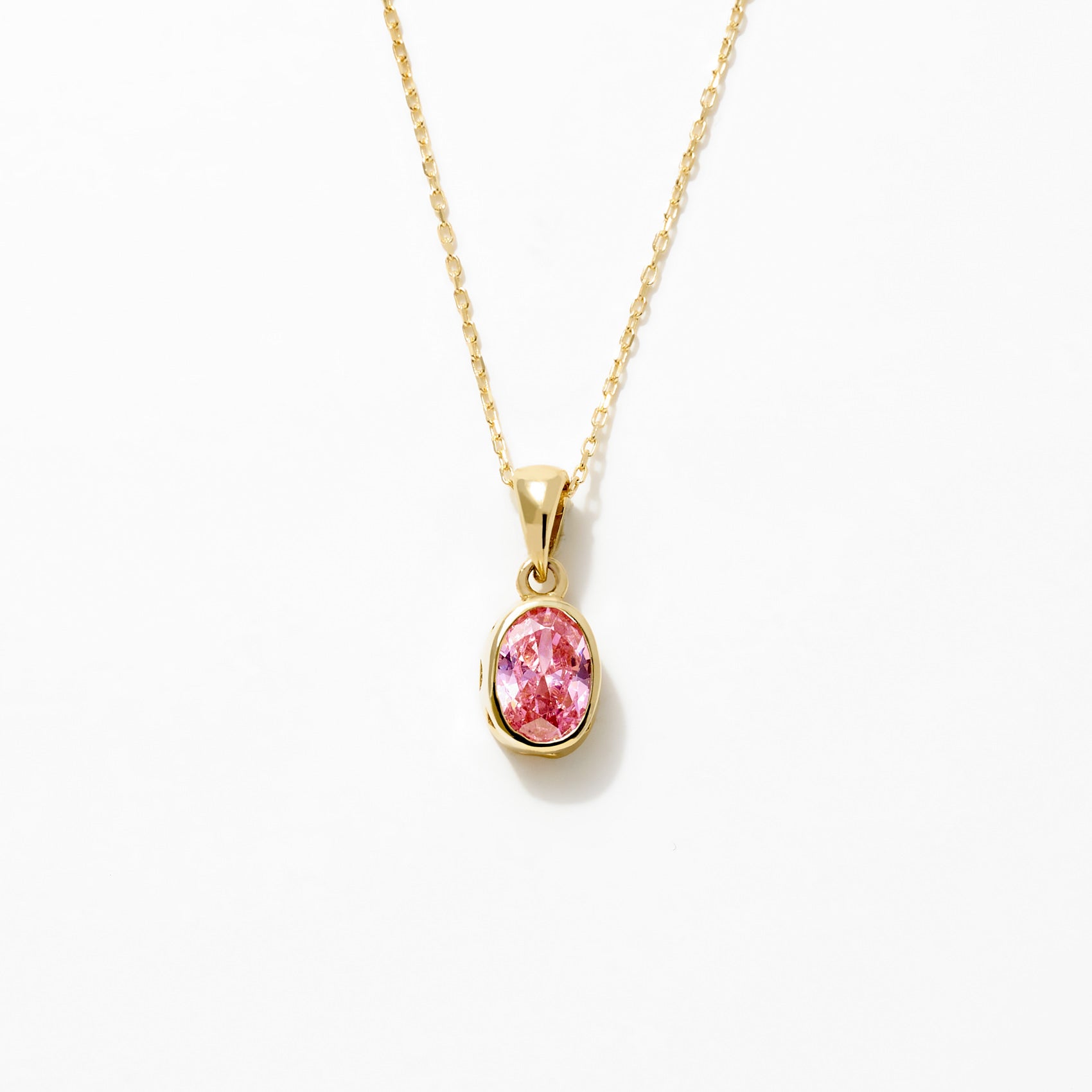 14K Gold Pink Sapphire Oval Pendant Necklace featuring a vibrant pink sapphire in a gold bezel setting.