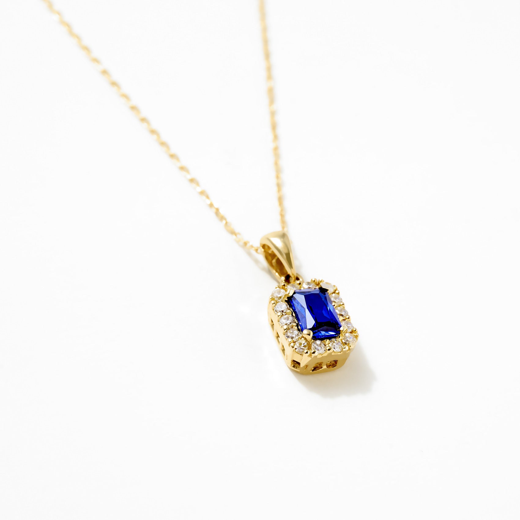 14K Gold Sapphire and Diamond Halo Pendant Necklace with rectangular-cut sapphire and diamond halo.