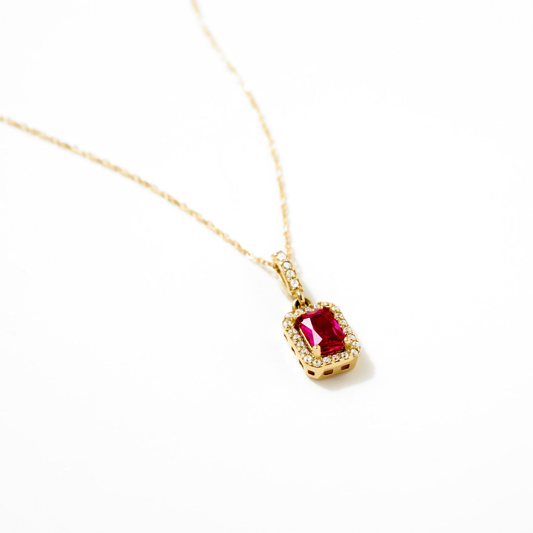 14K Gold Ruby Pendant Necklace with a rectangular ruby and diamond accents on a delicate gold chain.